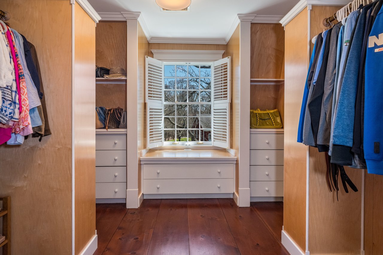 Primary Closet with built in cabinetry.
