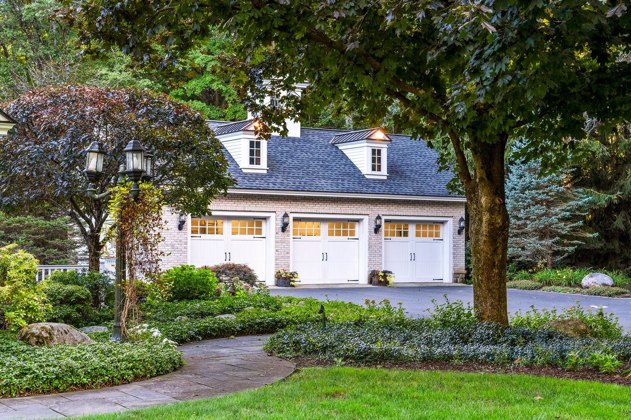 Entry drive to home has a fantastic three car garage and an additional three car garage on the lower level in the back