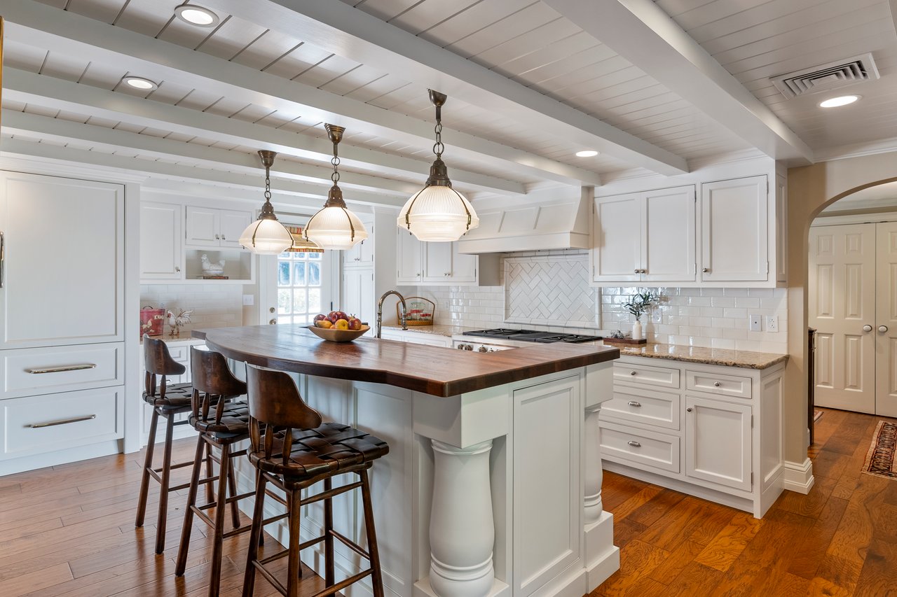 Understated, gorgeous, white kitchen with high end Sub-Zero and Wolf appliances