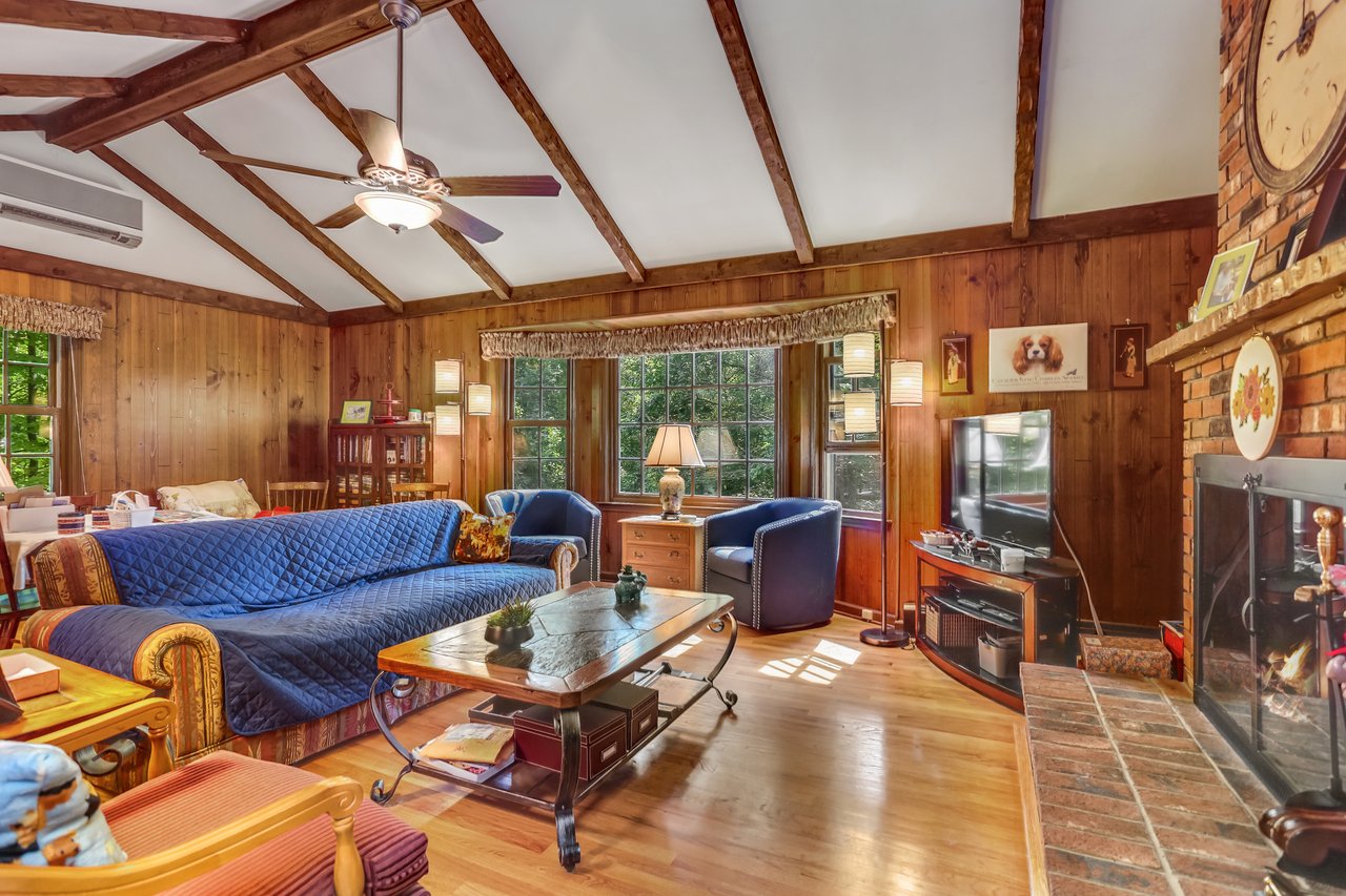 The Family Room with its Cathedral beamed ceiling and bay window faces south for natural light most of the day!	