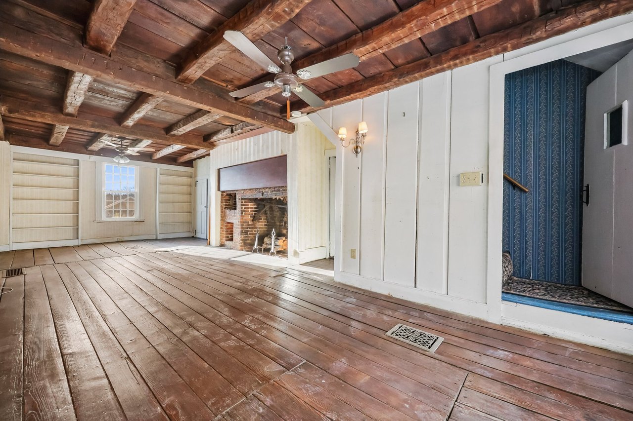 The Family room without staged furnishings so that the width of the floor boards is evident.