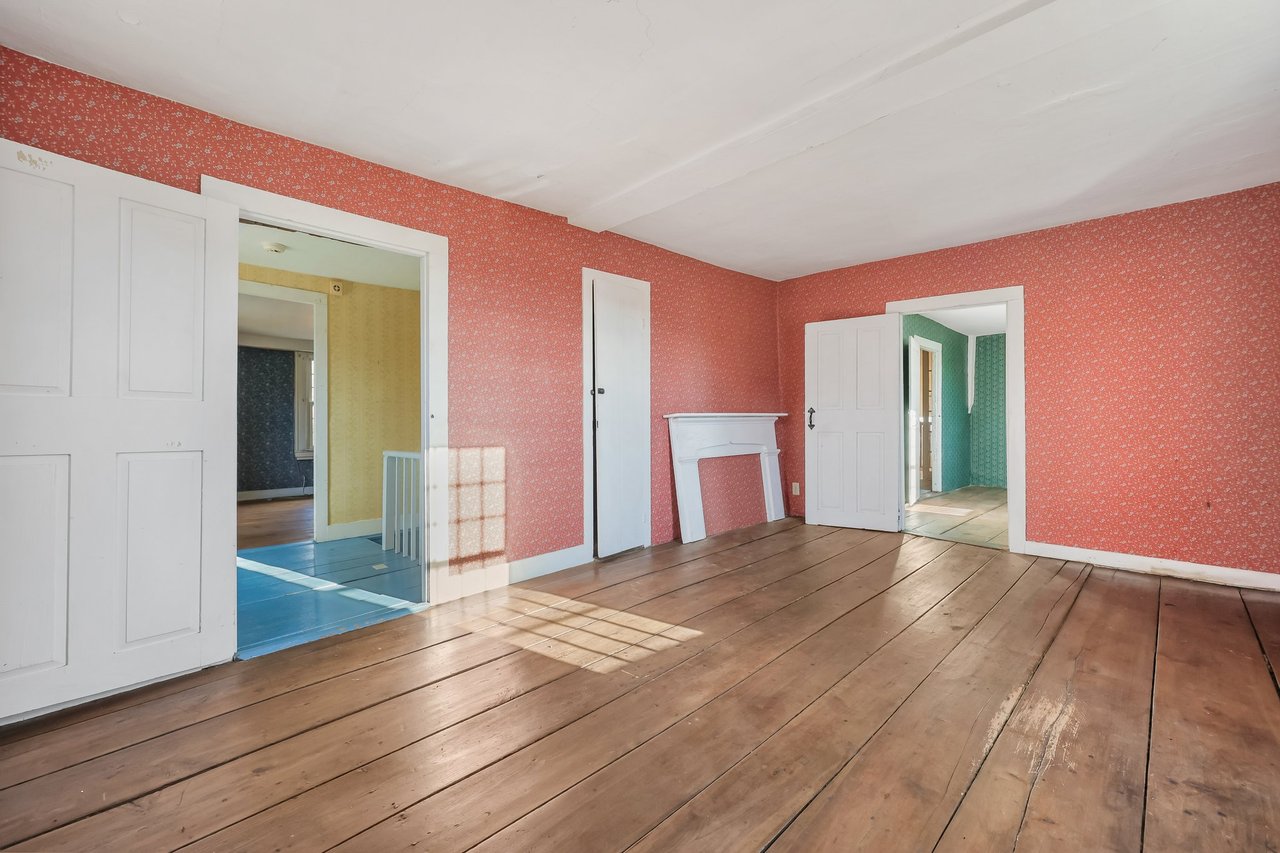 Upstairs bedroom with wide board floors, a true antique.