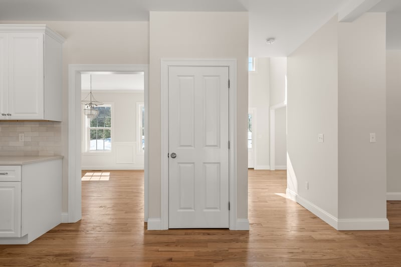 Kitchen looking in to the dining room and entrance foyer. Standard trim package and flooring are depicted in this photo.