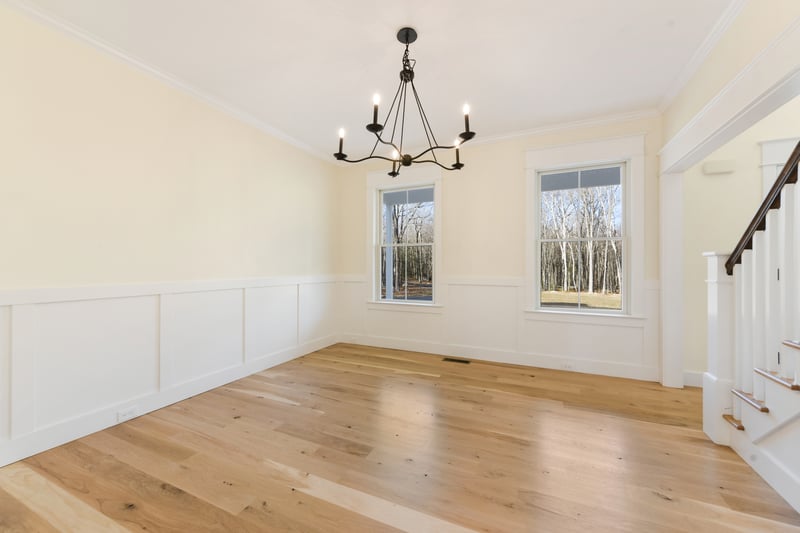 Lovely shaker style trim package and character grade white oak flooring are options and are depicted in this custom built home...a sunlit formal dining room