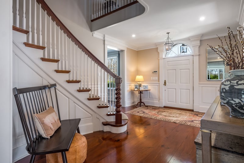 The custom newel posts on this stairway are one of the many custom woodwork details that highlight this home.