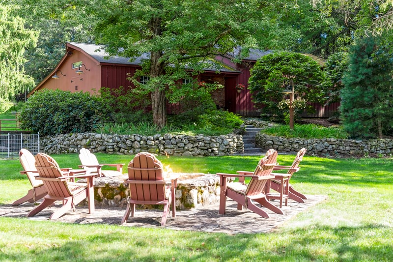 Enjoy this nature preserve get-a-way, an outdoor firepit with stone walls and walkway to barn