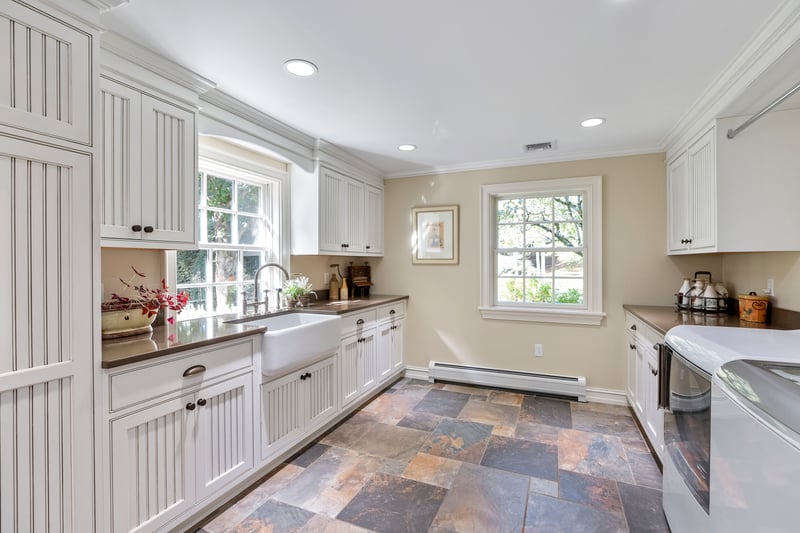 This sunlit, fully equipped laundry room offers all the bells and whistles to make household tasks a breeze